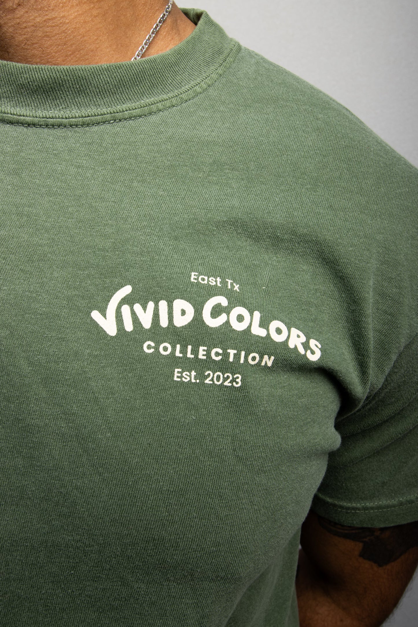 Close up of the Vivid Colors logo on the cafe t-shirt