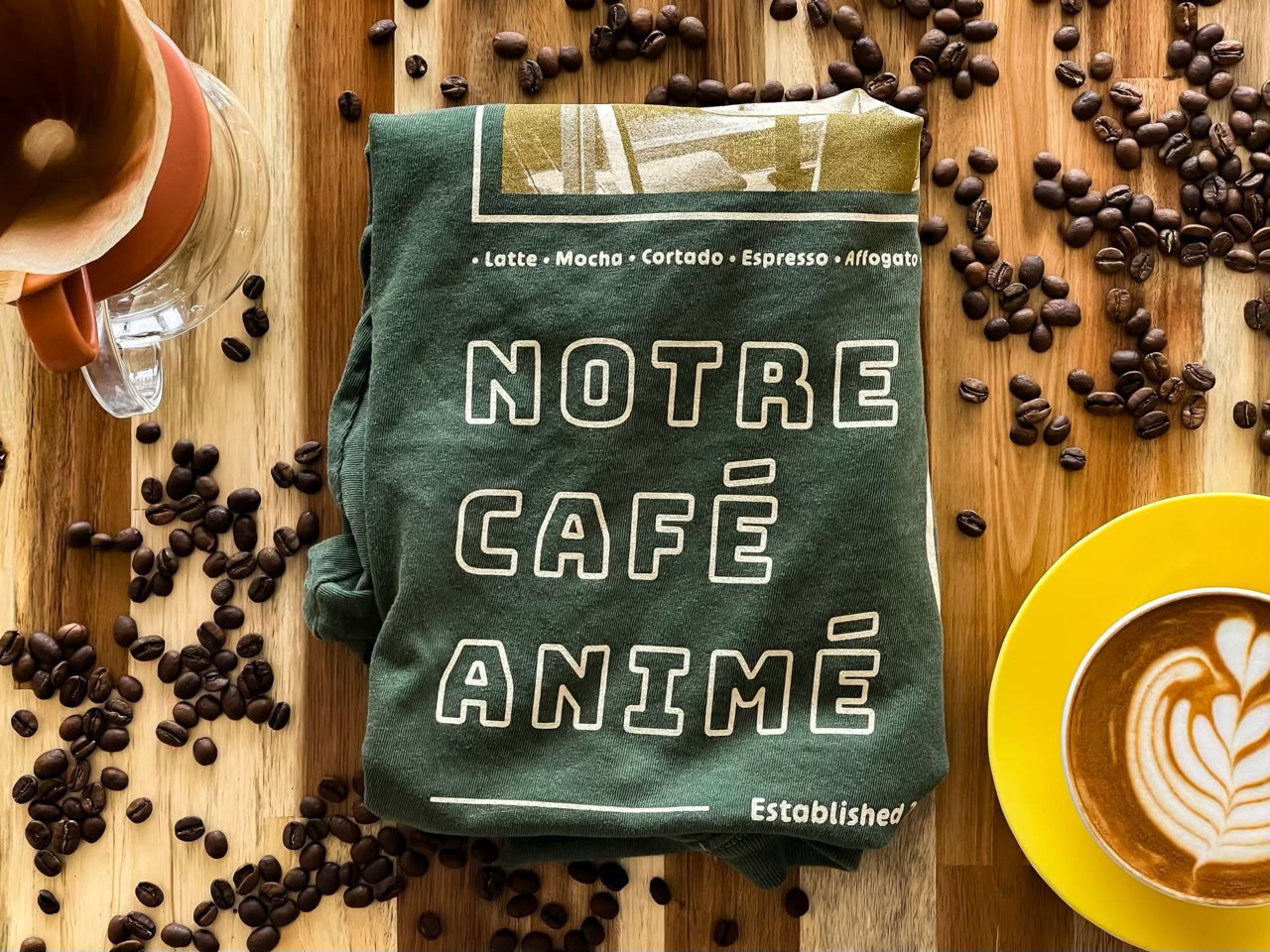 Folded vivid colors cafe shirt in a cafe surrounded by coffee and coffee beans